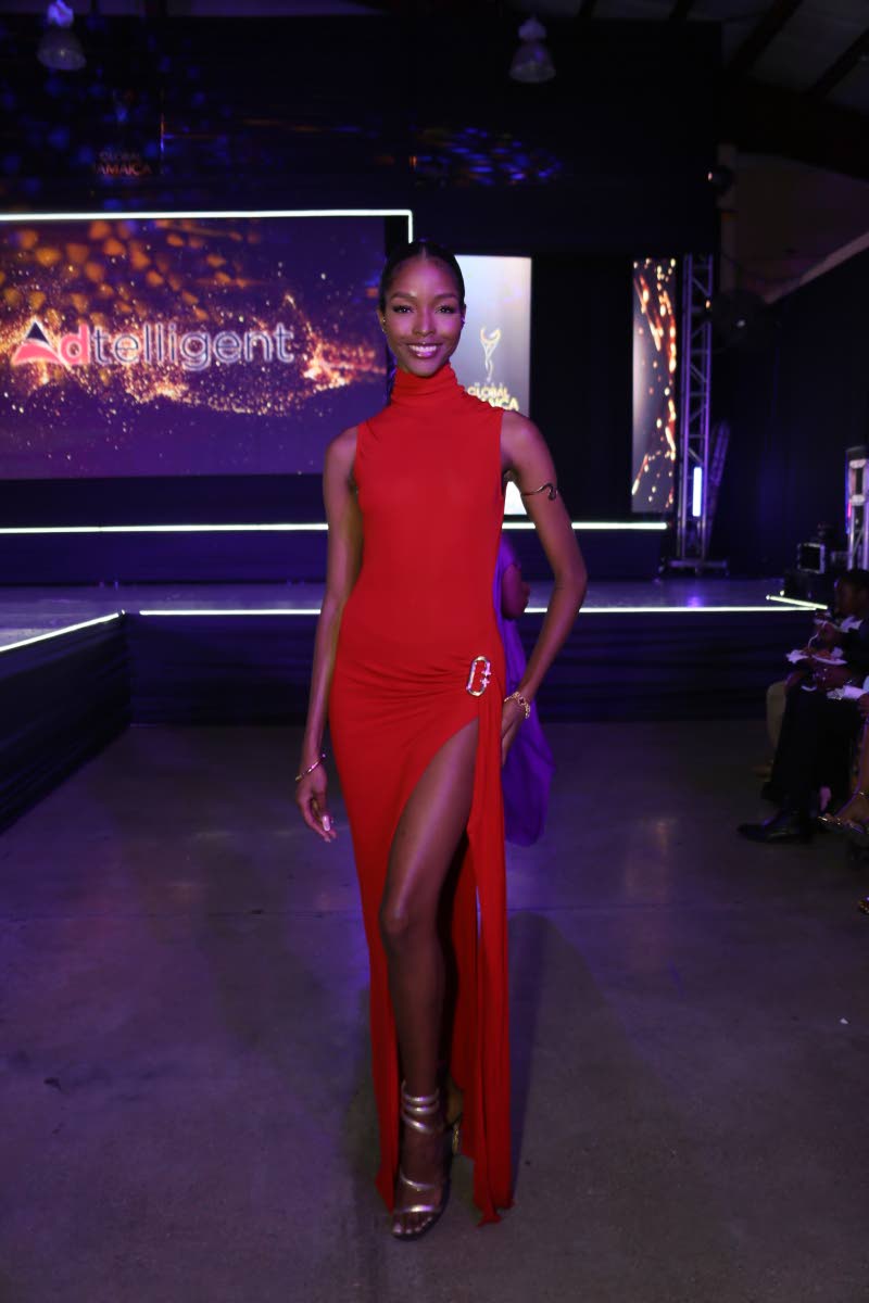Miss Universe Jamaica 2020 Miqueal-Symone Williams stuns in red, flaunting a daring thigh-high slit.