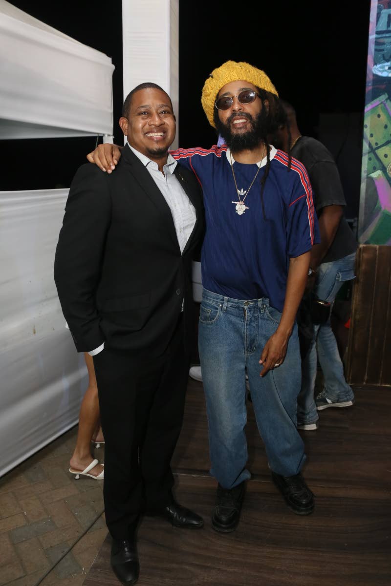 Minister of Agriculture, Fisheries and Mining Floyd Green (left) catches up with reggae star Protoje at Kuyah.
