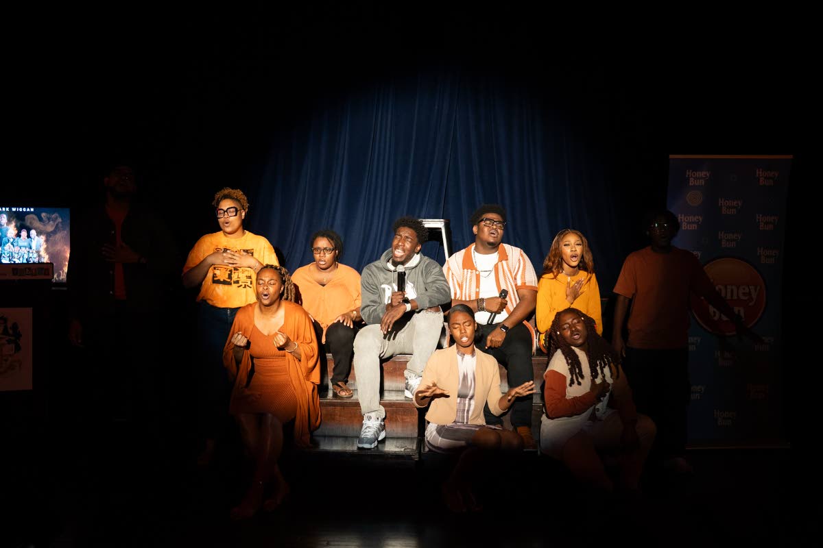 Genesis Praise Squad join Johnmark Wiggan (centre) on stage for a surprise flash-mob style performance that opened the ‘By Fire’ media launch.