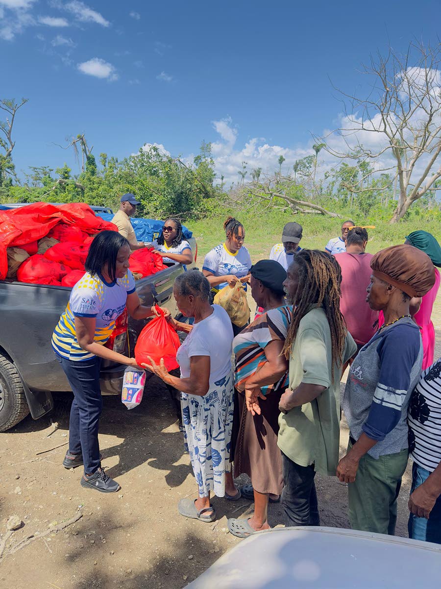 Members of the Shipping Association’s team distributing relief packages to residents in Watercress, Westmoreland.
