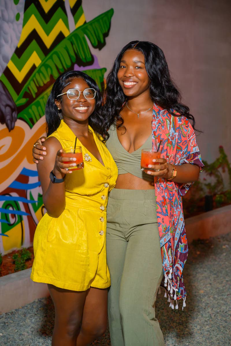 Sisters Ashanique (left) and Reanna Shakespeare raise their drinks to a good night.