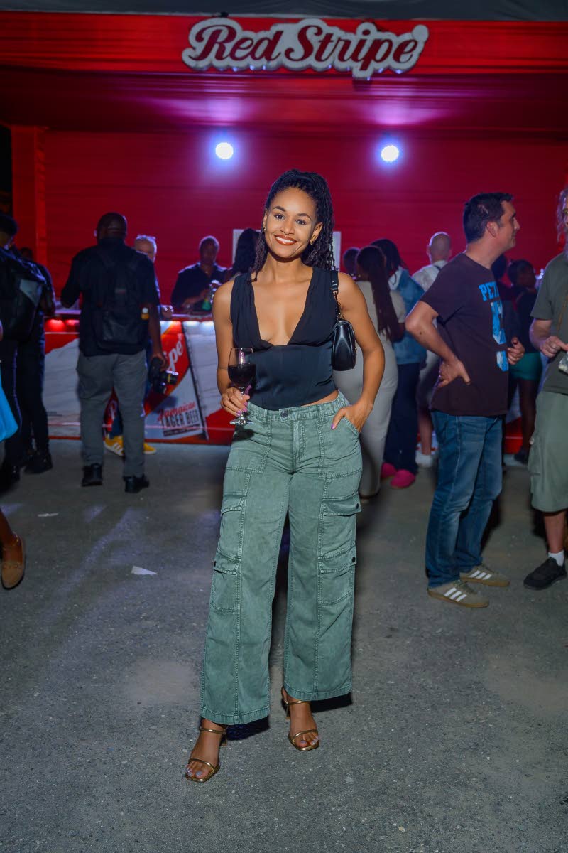  Dr Sanneta Myrie enjoys a glass of red wine during the relaunch festivities at Tuff Gong International.