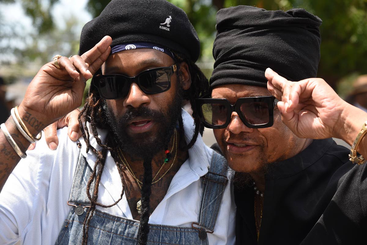 Showing their support, following their musical tribute are Tarrus Riley (left) and Maxi Priest.