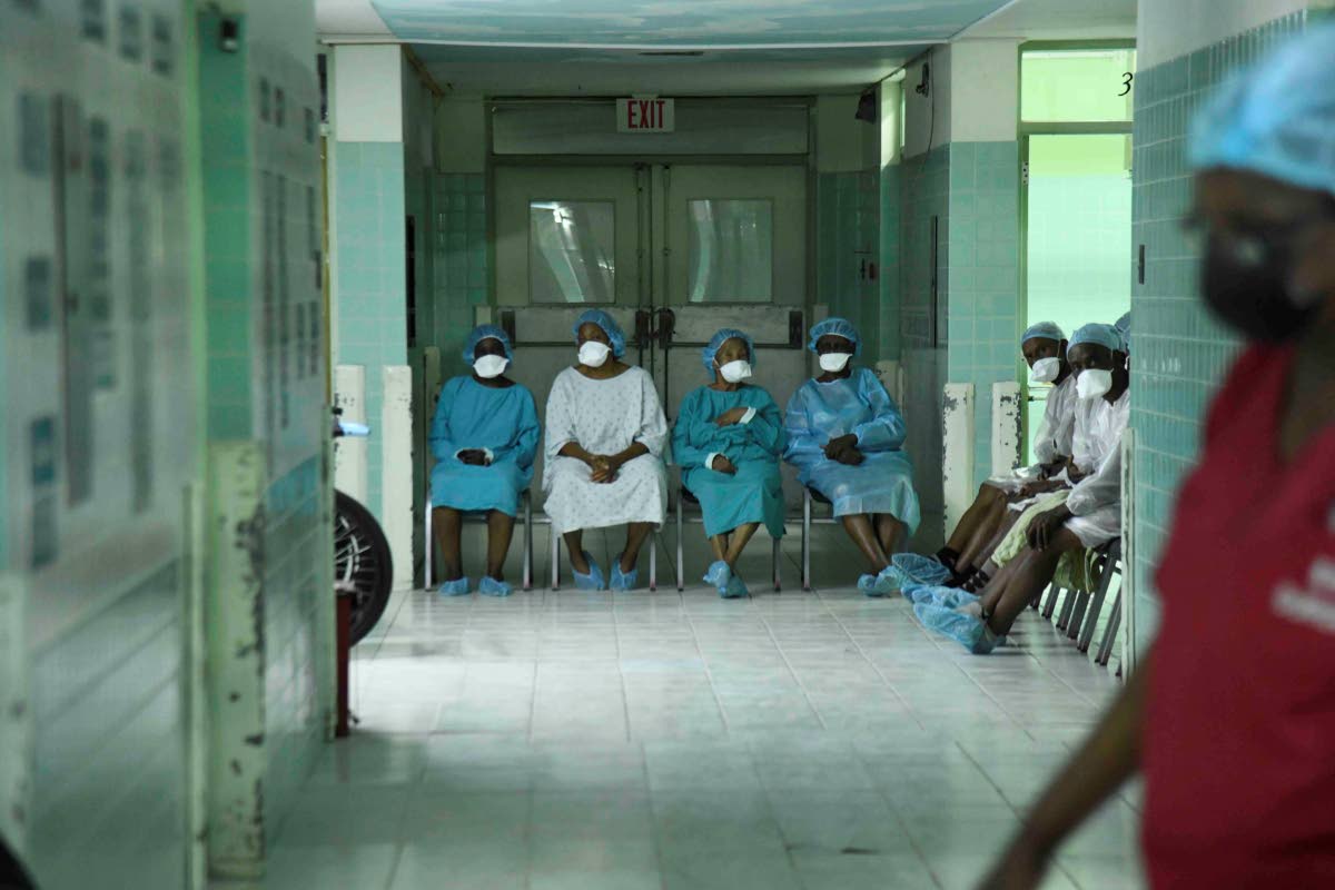 Surgical patients wait to be served inside the eye clinic at St Joseph’s Hospital in Kingston yesterday.