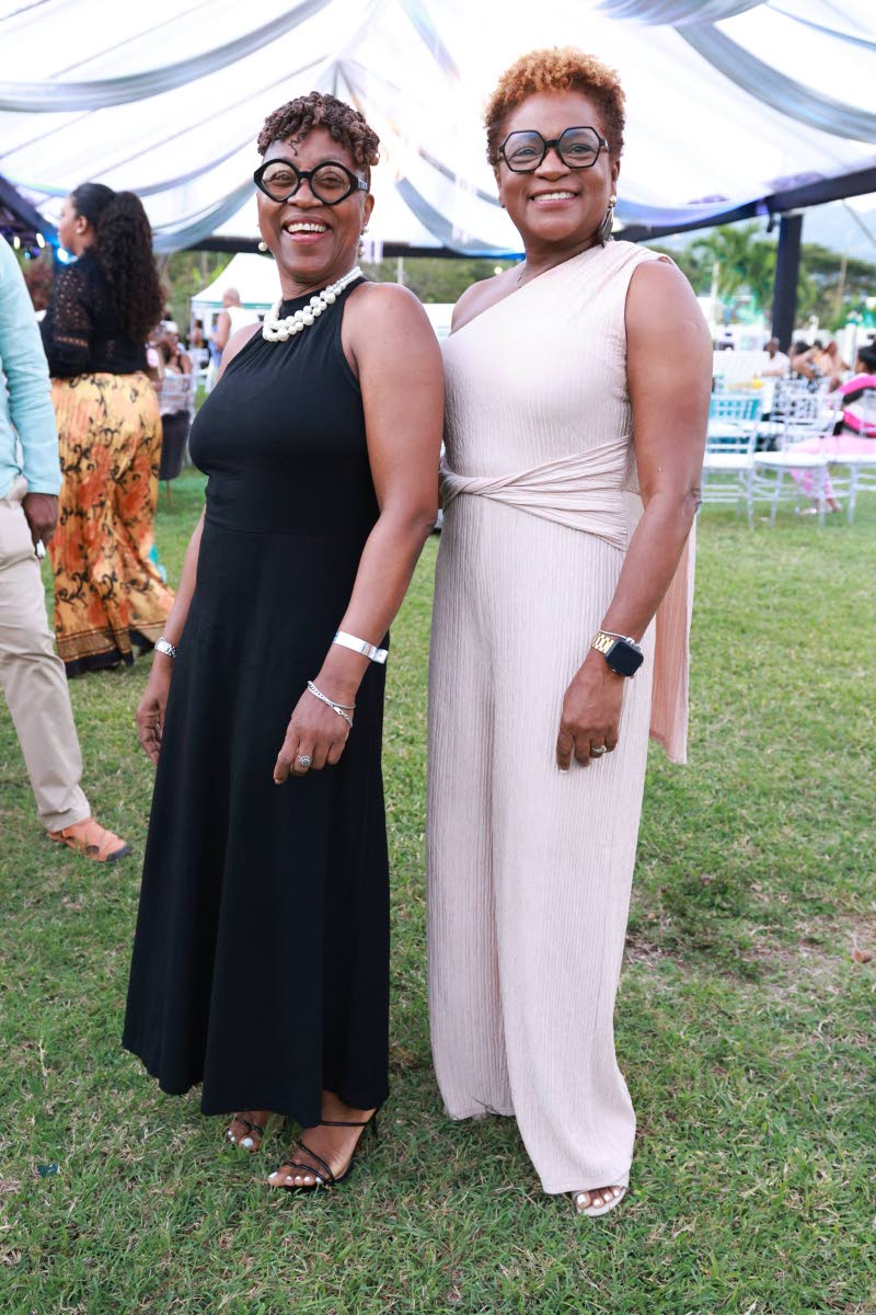 Senior Parish Judge Paula Blake-Powell (left) poses with Darlene Jones, executive director of the Jamaica Institute of Financial Services, for a quick photo.