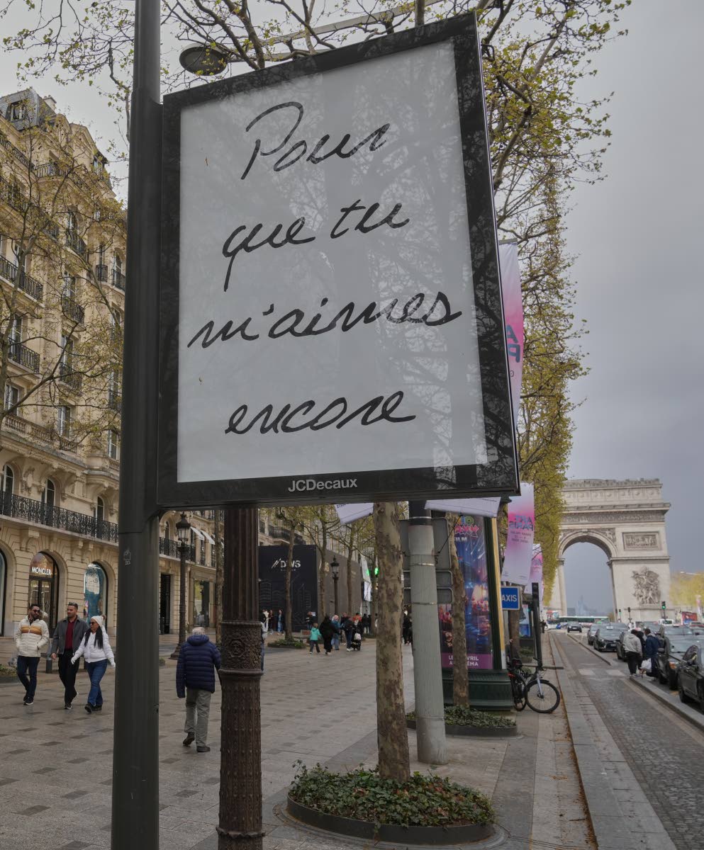 A poster featuring the French title of Celine Dion’s song ‘If That’s What it Takes’, promoting autumn concerts in France on the Champs-Élysées in Paris on Wednesday.
