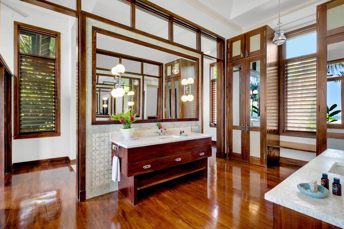 A bathroom featuring opposite his and her basin vanities.