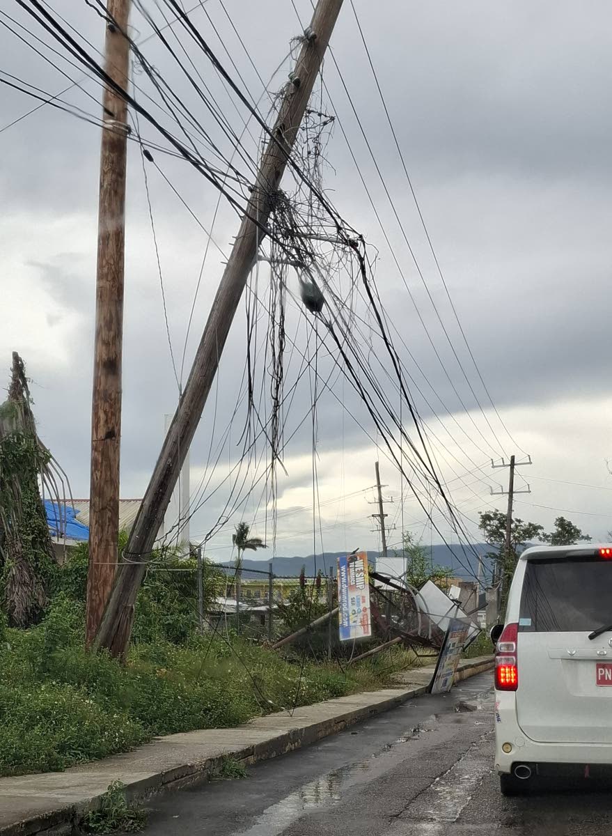 Low-hanging wires line in a section of Savanna-la-Mar, months after infrastructure damage caused by Hurricane Melissa.