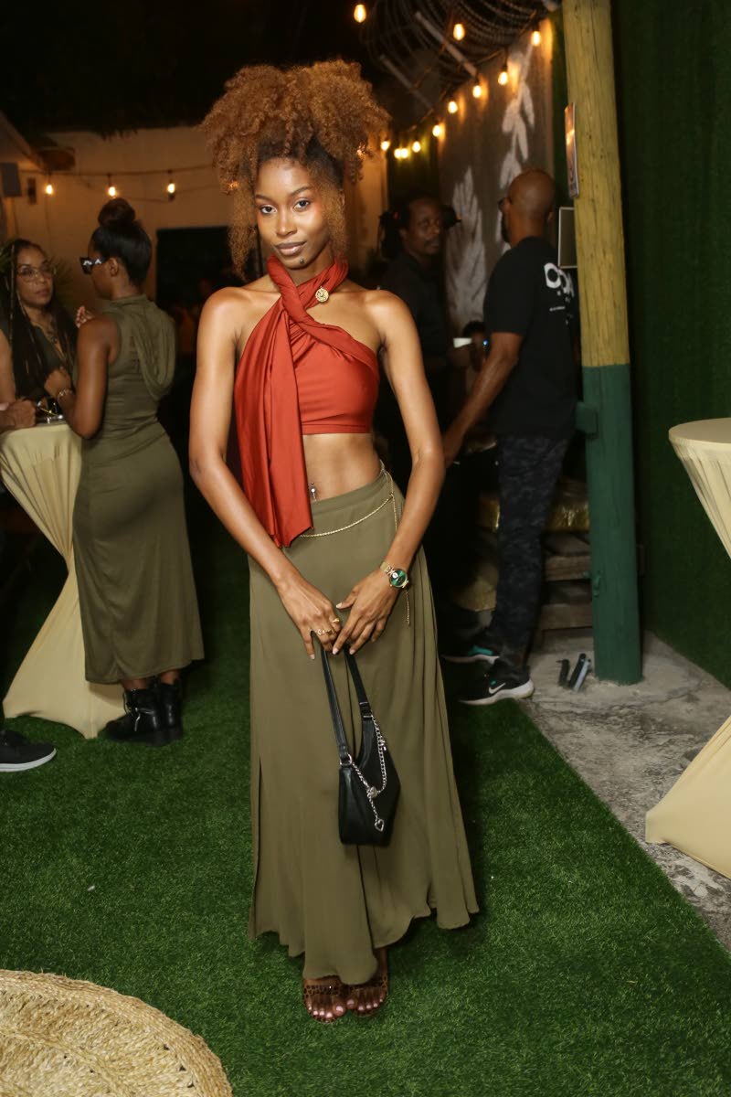 Recording artiste Akina Eman channels regal elegance in a satin wrap top and flowing maxi skirt.
