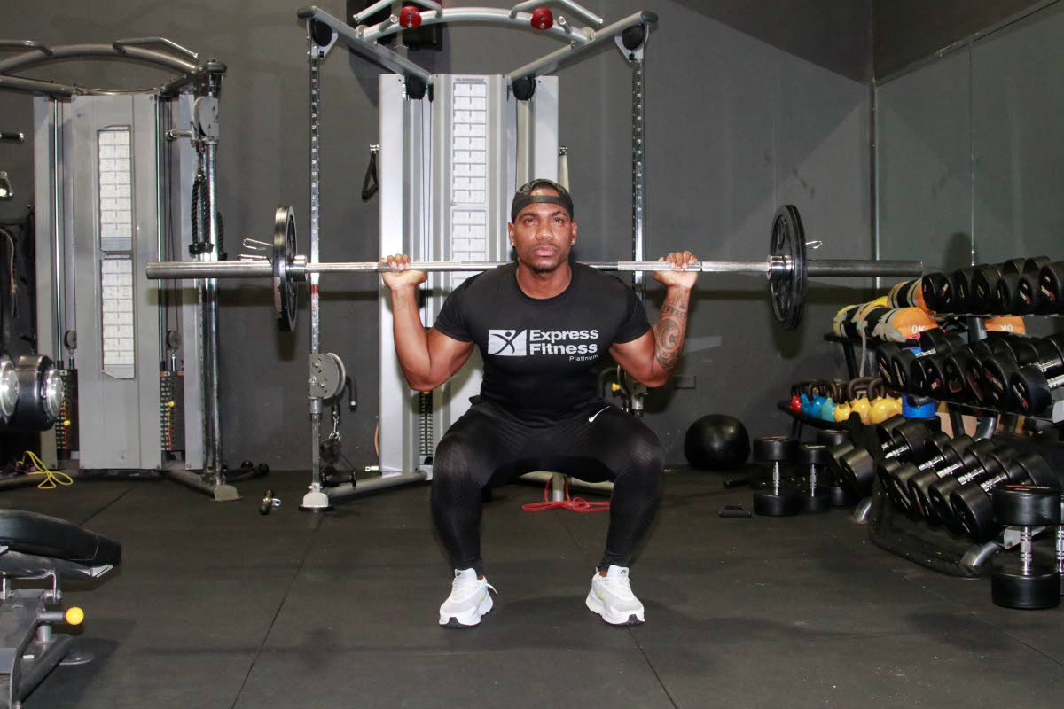 The barbell back squat requires placing the barbell across the upper back, squatting down and driving back up.