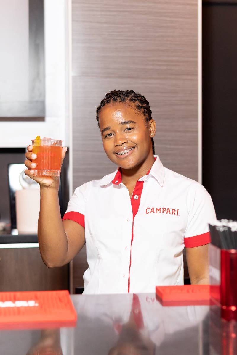 Shanice Mitchell, brand activator, Campari Group, raises a cocktail in hand at the lyme and mixology experience.