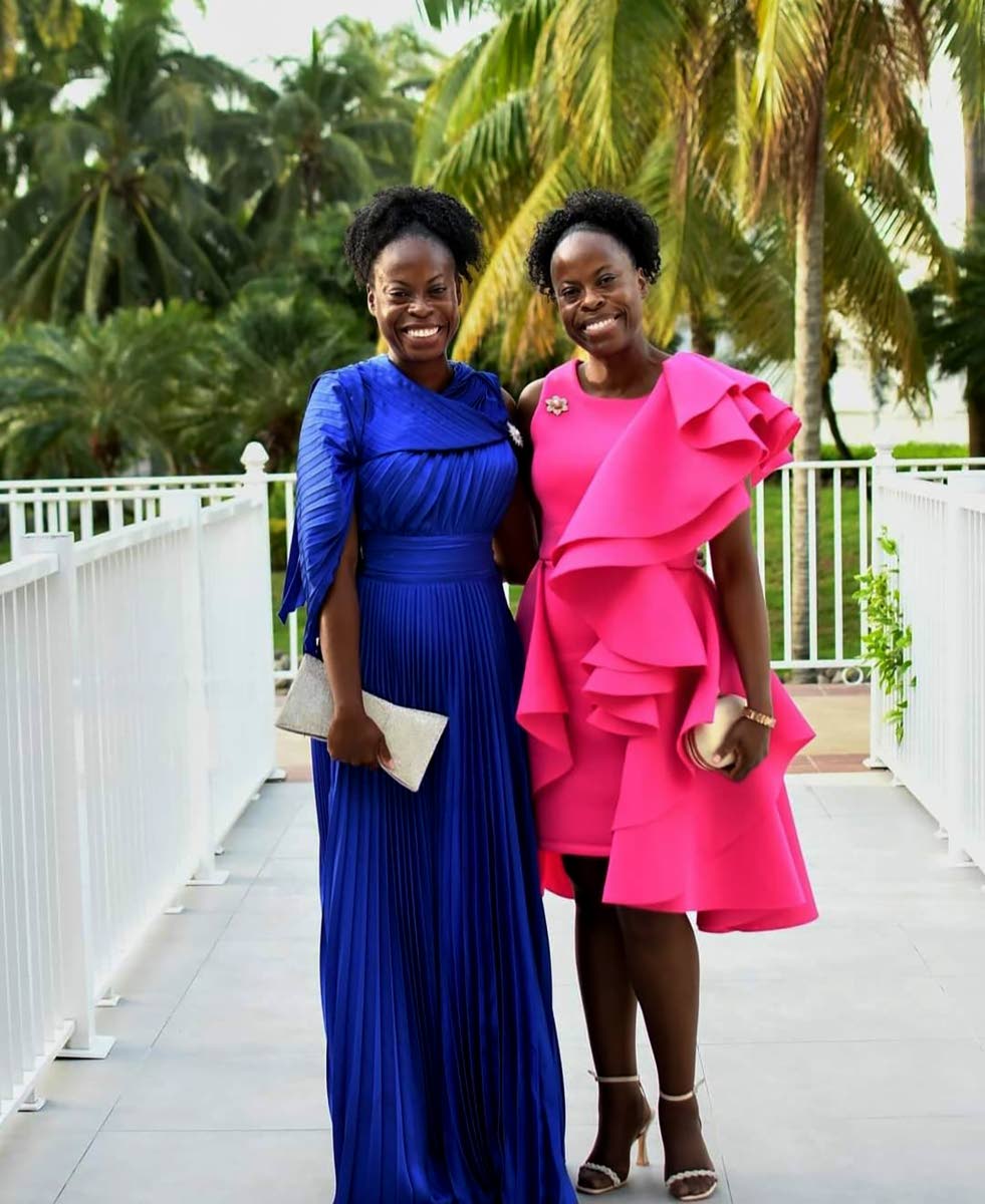 Dr Tamika Henry (left) and her sister Dr Tamara Henry-Gilpin pose for a photo after an event.