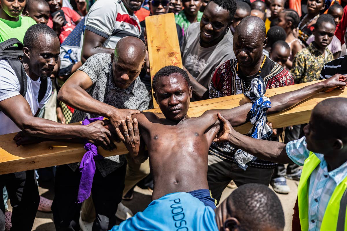 Christians take part in a Way of the Cross re-enactment of the crucifixion of Jesus Christ on Good Friday during Holy Week in Kibera informal settlement in Nairobi, Kenya.