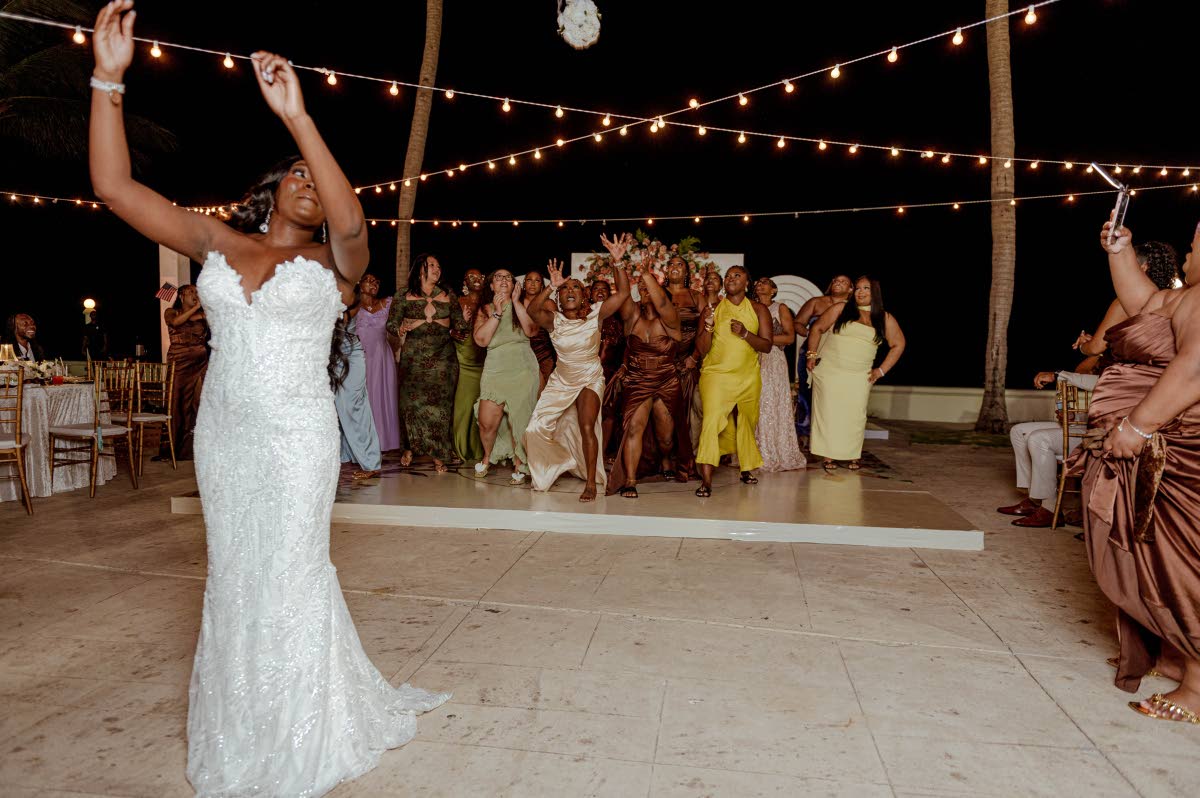 Chelsea tosses her bouquet during the reception festivities