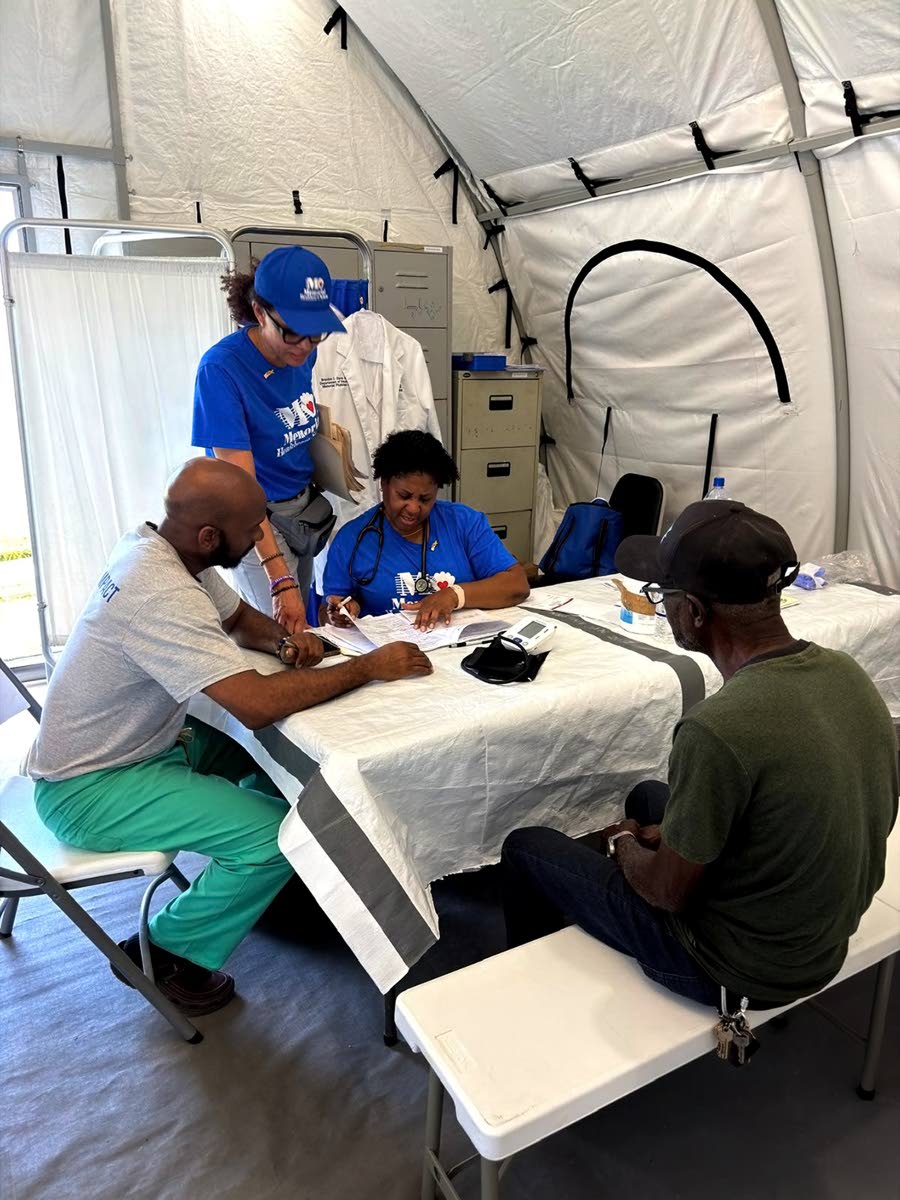 Dr Dahlia Blake, Dr Brandon Davis, and Dionne Blackwood discussing a patient’s case. 