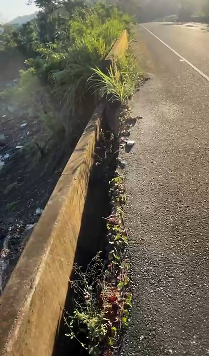 A wall on the approach to the bridge breaking away from the road surface. 