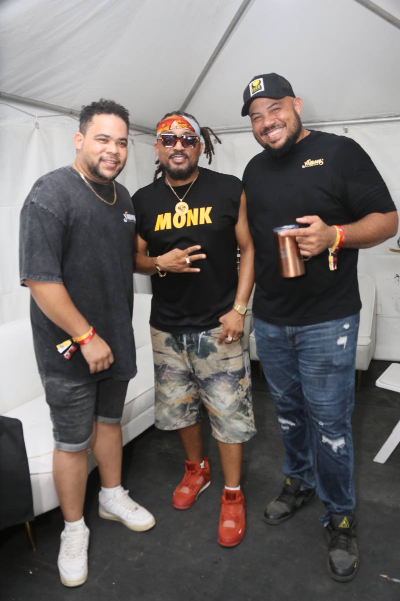 From left: DJ Richie R.A.S., soca artiste Machel Montano, and Yard Mas Carnival Managing Director Andrew Bellamy, mark the moment backstage with a photo.