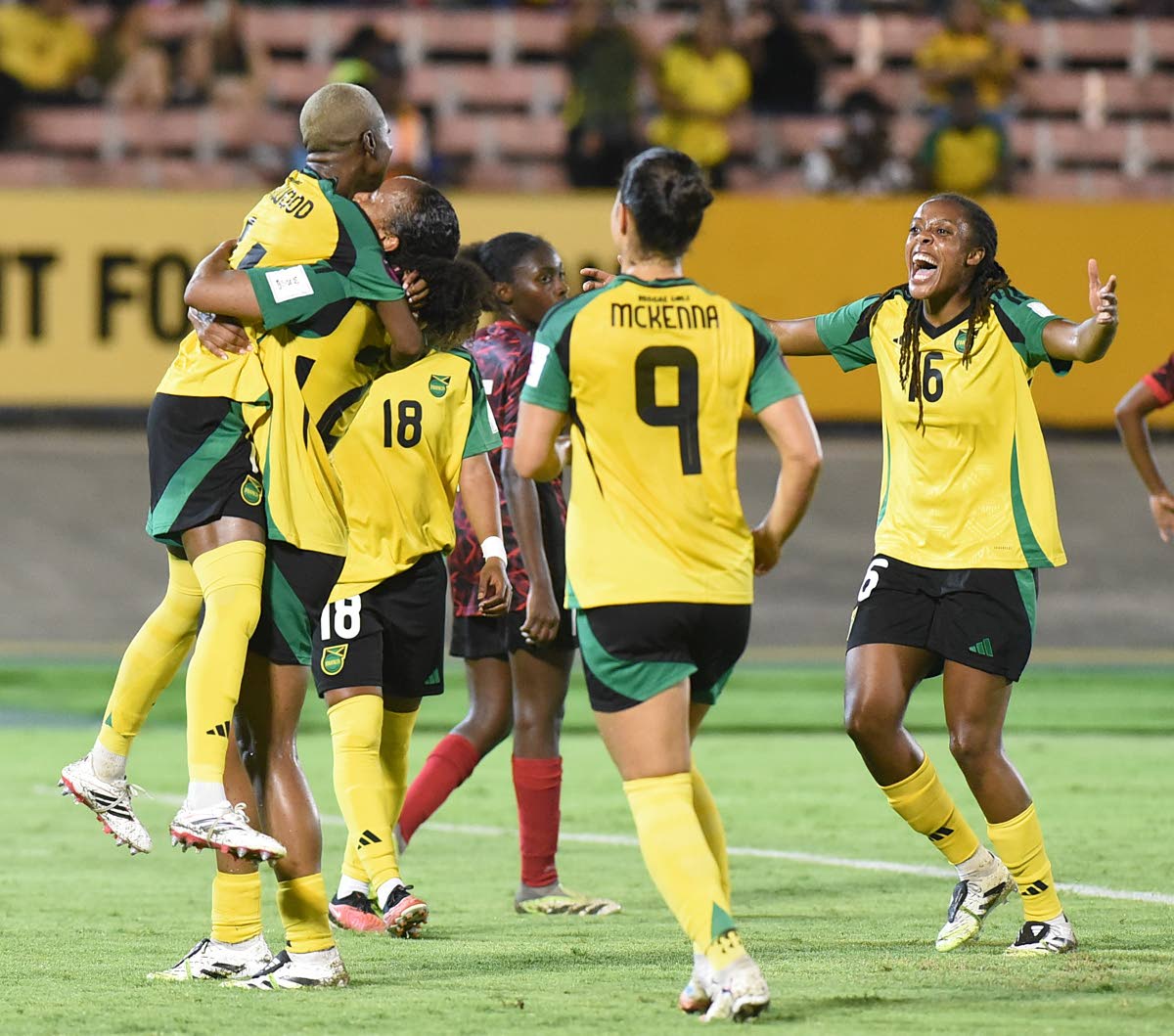 Jamaica’s Deneisha Blackwood (left) celebrates with teammates after she scored from the penalty spot to complete a 4-0 win for the Reggae Girlz in their Concacaf Women’s qualifier against Antigua and Barbuda at the National Stadium last night.