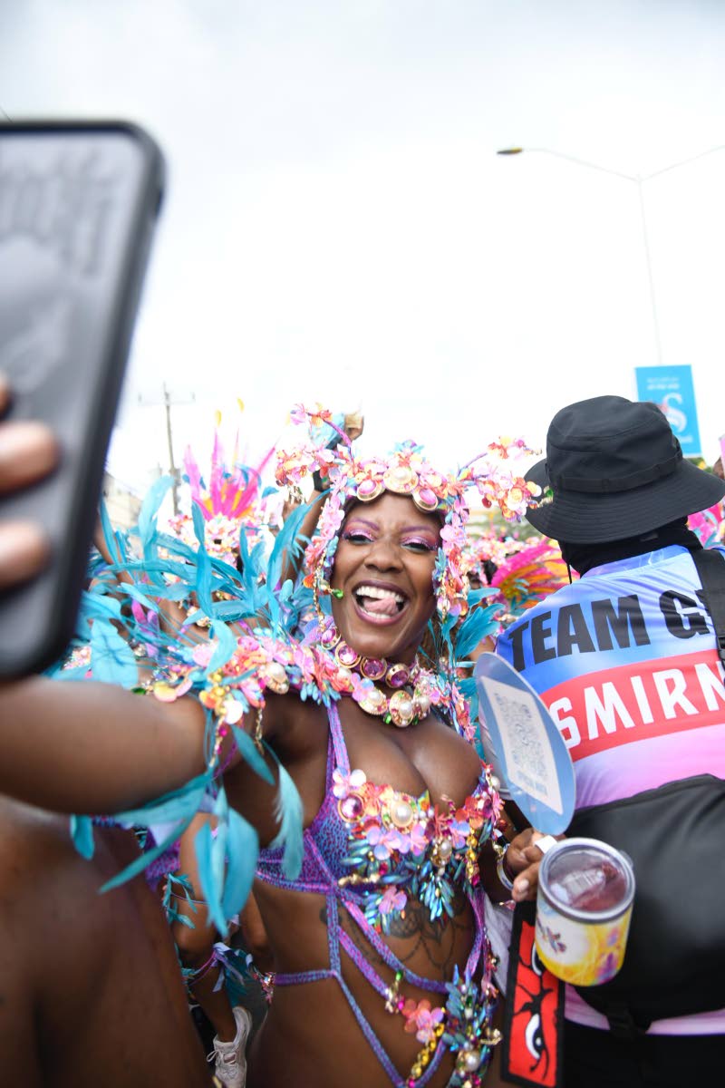 Taking a photo mid-mas, this reveller cherishes the moment.