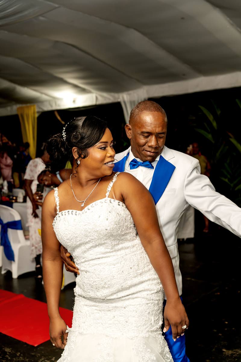 The newlyweds enjoy a fun dance moment during their reception held at Clarendon Paradise Garden in Toll Gate.