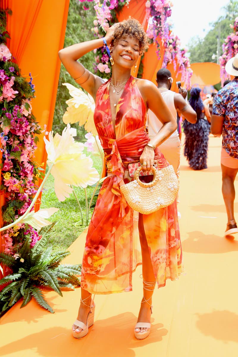Singer, songwriter and stylist, Elle, gives sunkissed bohemian babe in a plunging midi and whimsical rattan purse. 