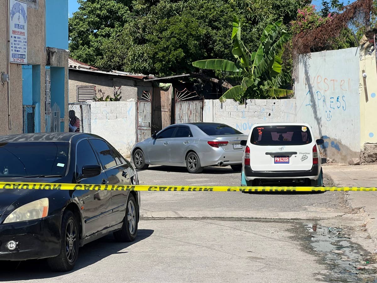 The open gates at premises where one of the men was killed.