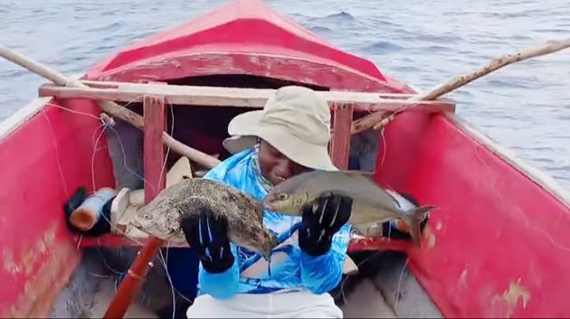 Shaw with two Yellow Tail fish that she caught in Boston, Portland, recently.
