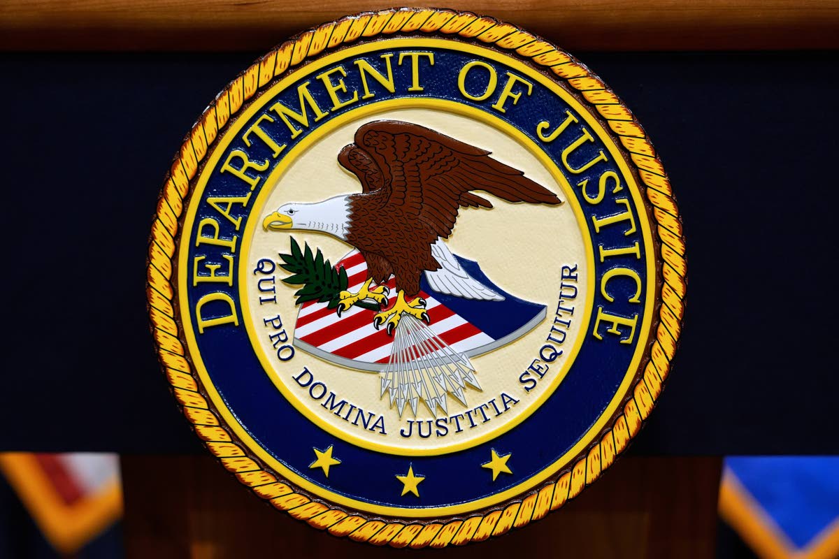 The US Department of Justice logo is seen on a podium before a news conference at the Justice Department in Washington, on May 6, 2025. (AP Photo/Julia Demaree Nikhinson, File)