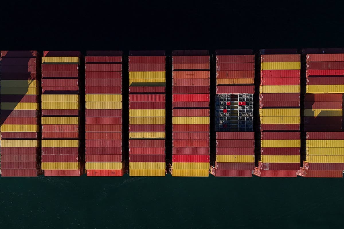 Cargo containers are stacked on a cargo ship moving through the Panama Canal, at sunrise in Panama City, Wednesday, March 25, 2026. (AP Photo/Matias Delacroix)