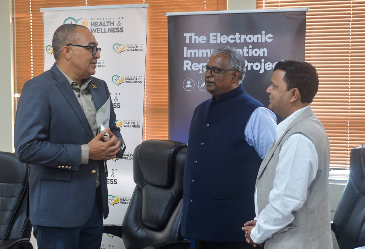 Minister of Health and Wellness, Dr Hon. Christopher Tufton (left), converses with Managing Director of ArguSoft America Incorporated, Ram Gopalan (centre), and President of Professional Services at Argusoft America Incorporated, Ravi Shankar, following th