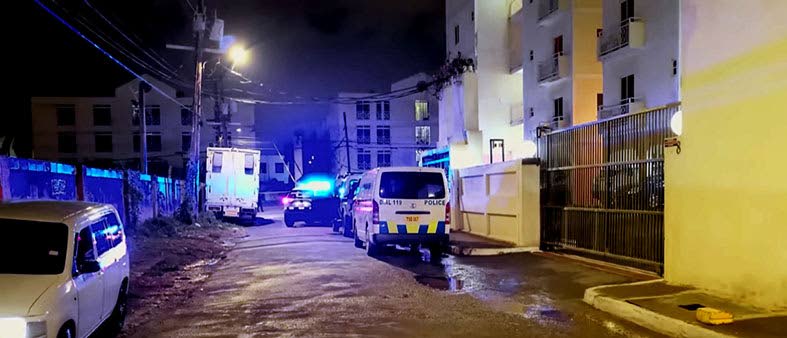 The police on the crime scene in the vicinity of Kensington Court in New Kingston on Friday night.