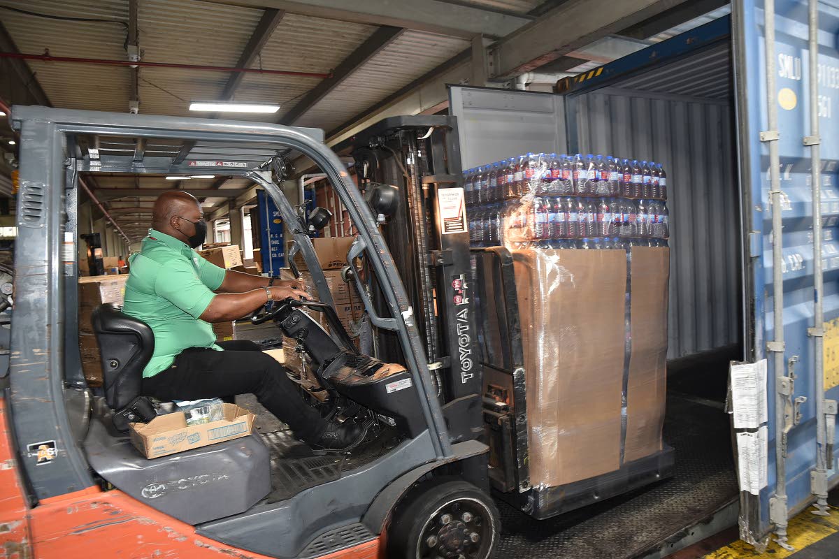 Wisynco Group Limited - workman loading goods at company complex in St Catherine