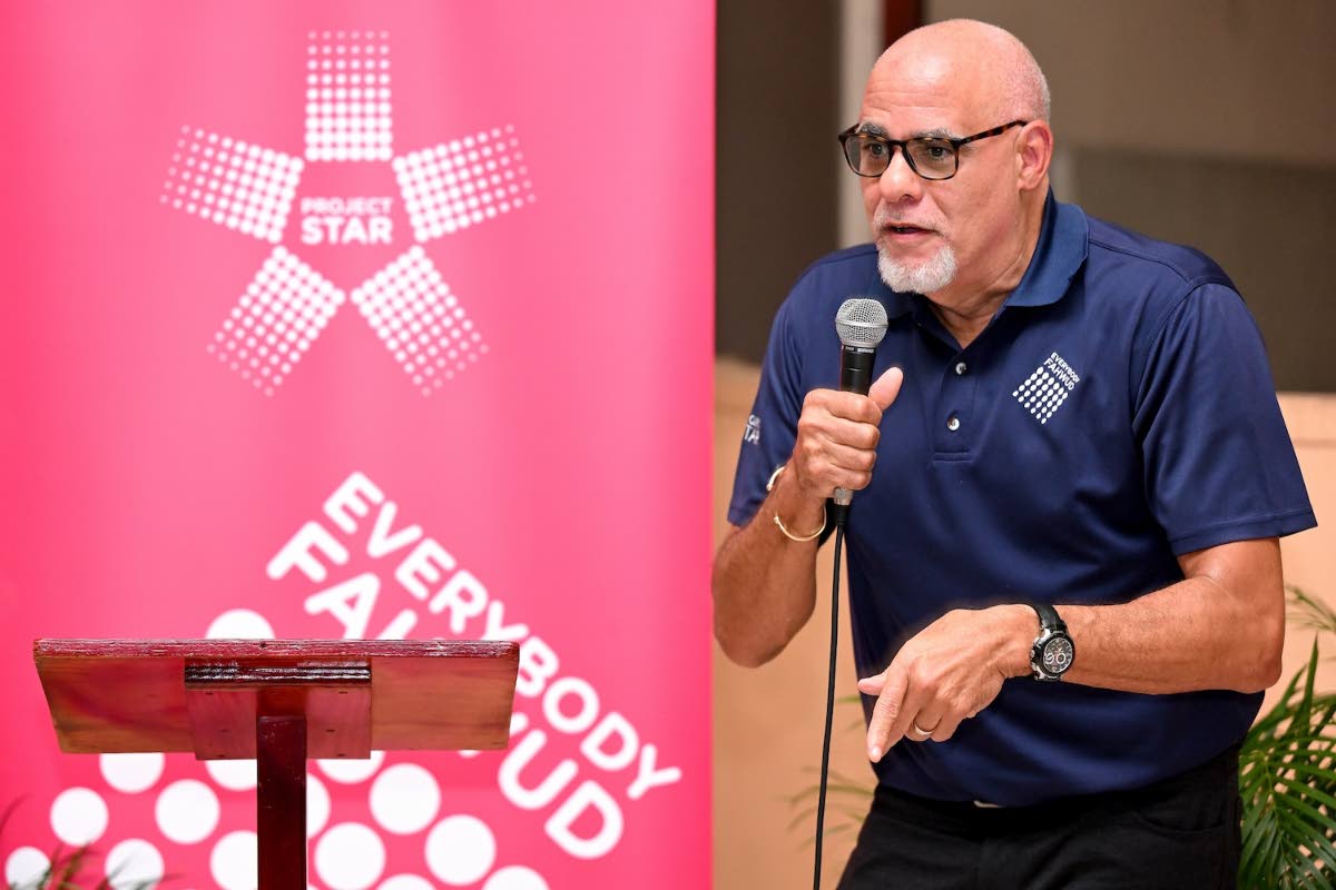 Keith Duncan, project sponsor, Project STAR, addresses attendees at the Rose Gardens Town Hall hosted by Project STAR at Pentab High School in Kingston.