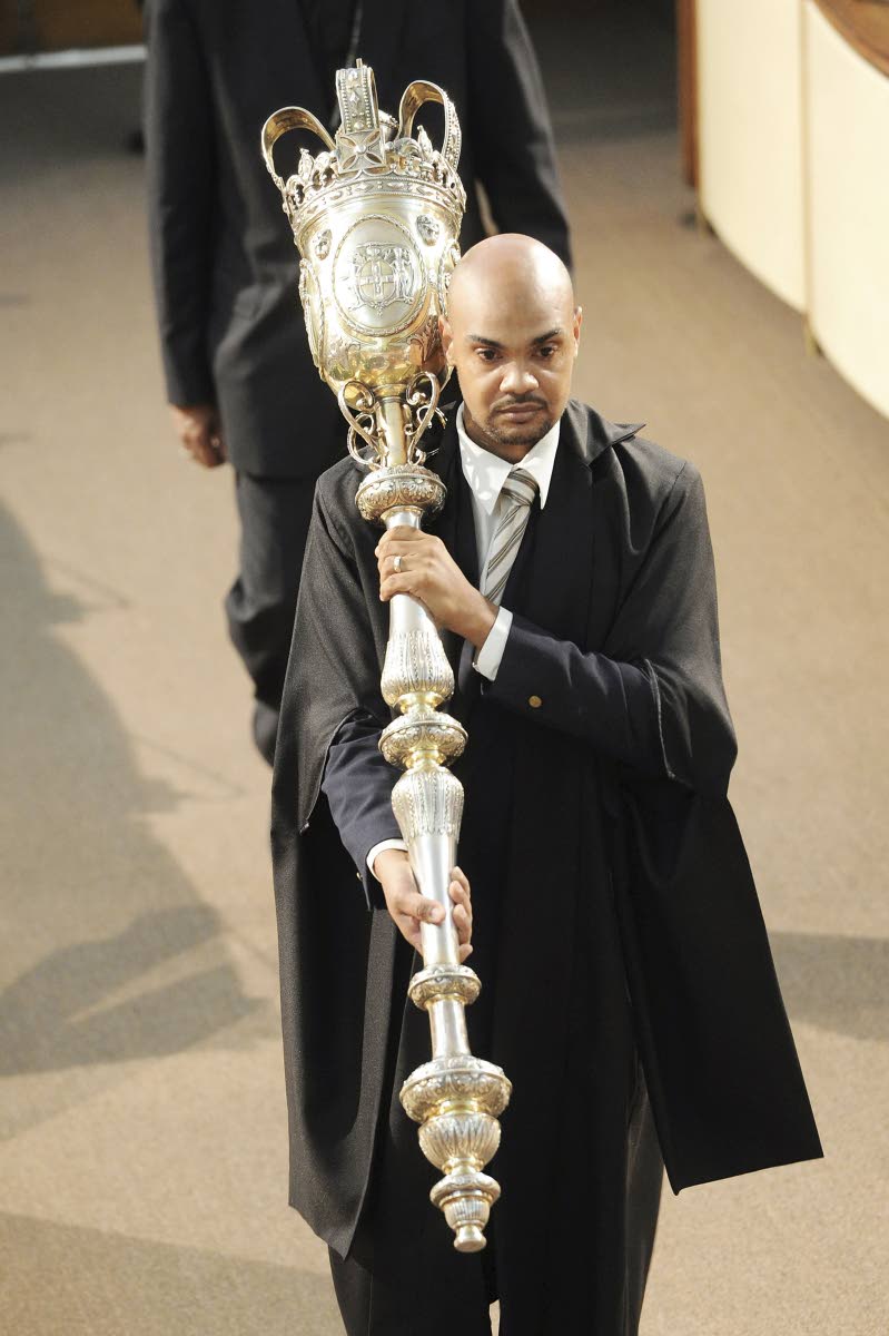 The then new House marshal, Kevin Williams, carries the mace during the opening of the new session of Parliament in 2012. The current House marshal is Captain Wayne Blake. 