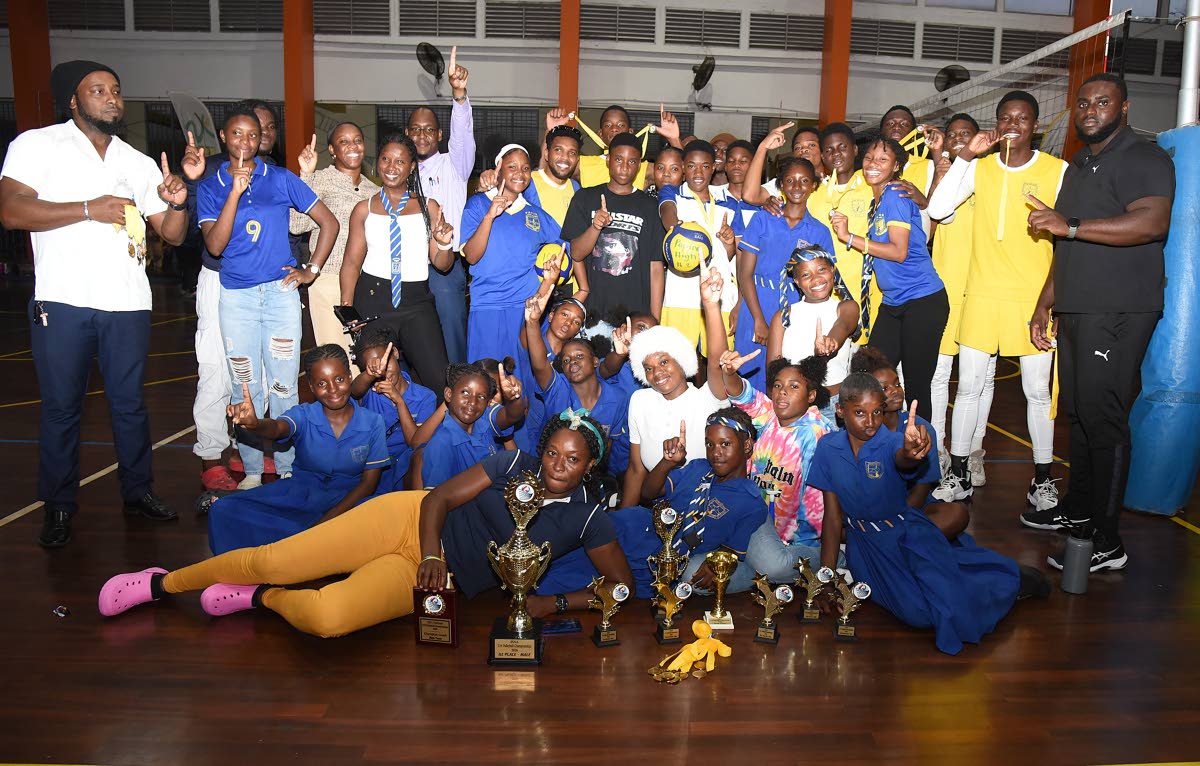 Members of Papine High School celebrate after defeating Oracabessa High in the final of the ISSA All-Island Volleyball competition at the G.C. Foster College yesterday.