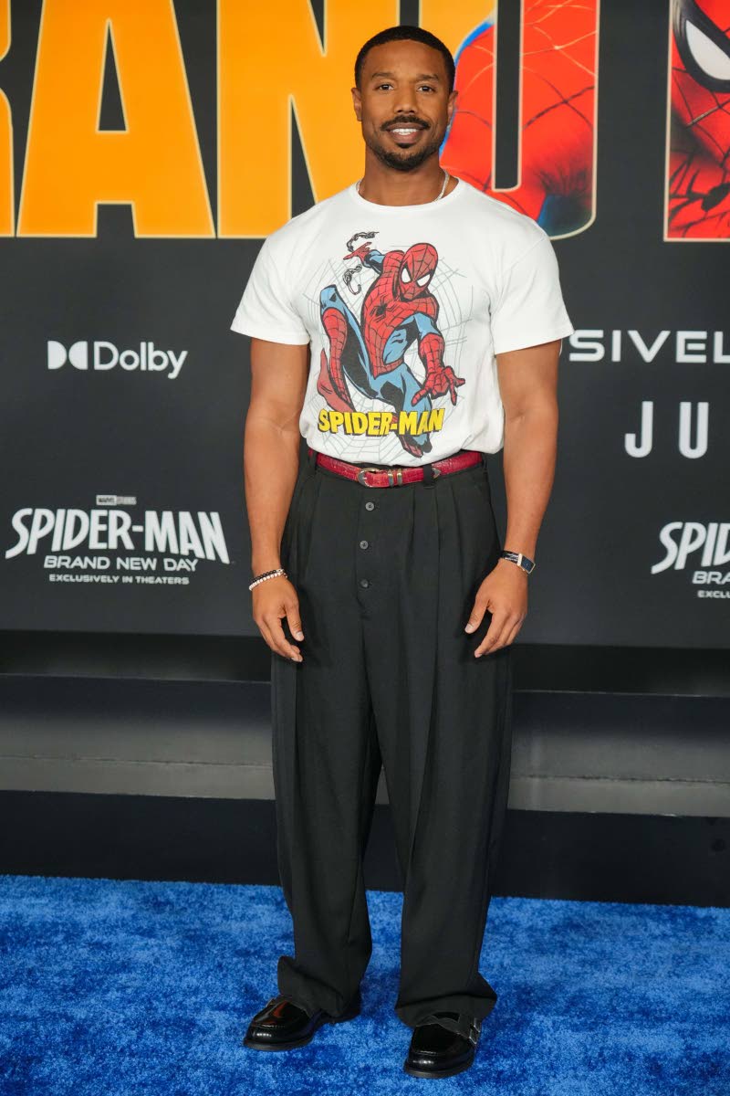 Michael B. Jordan wears a vintage Spider-Man T-shirt paired with Jacquemus’ Le Pantalon Fernando trousers and Grenson Shoes’ The Double Monk Loafers.