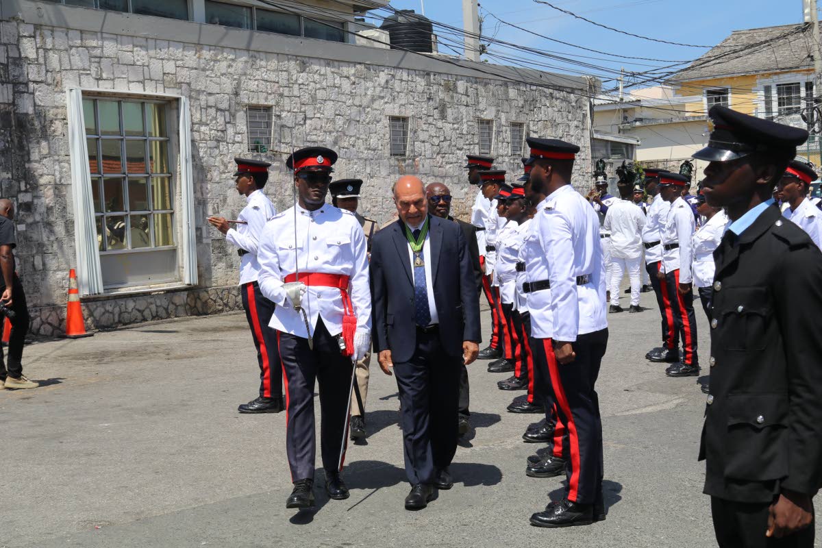 Trelawny Custos Rotulorum Hugh Gentles inspects the guard of honour, accompanied by inspector Neil Anthony Brown of the Trelawny Division of the Jamaica Constabulary Force, during the Independence Civic Ceremony in Water Square, Falmouth, on Thursday.