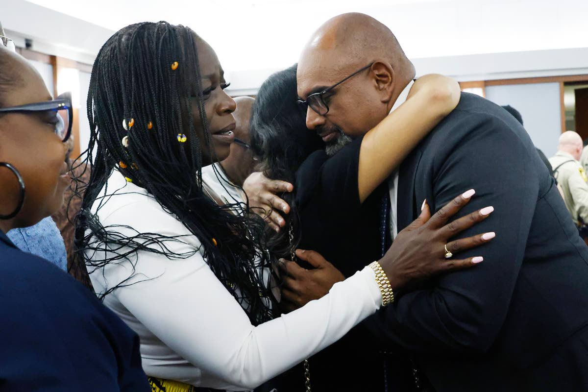Friends and family members of rapper Tupac Shakur, including his sister, Sekyiwa Shakur (second left), line up to hug Chief Deputy District Attorney Binu Palal (right), after a jury found Duane Davis guilty of first-degree murder in his trial related to th