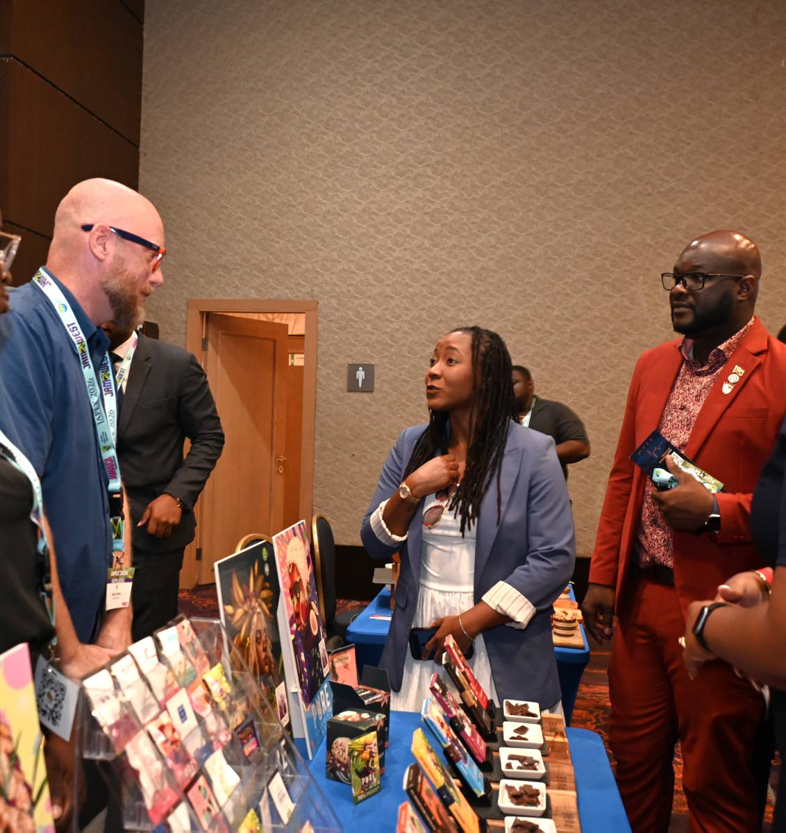 Tova Hamilton (centre), minister of State in the Ministry of Tourism, greets Wouter Tjeertes (left), co-founder of Pure Chocolate Jamaica, while O’Brian Herron, president of Jamaica Hotel and Tourist Association, looks on during a tour in the exhibition 
