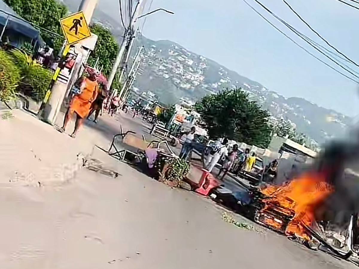 A fiery roadblock mounted along Red Hills Road in St Andrew by residents protesting a fatal police shooting on September 16, 2026. - Contributed photo