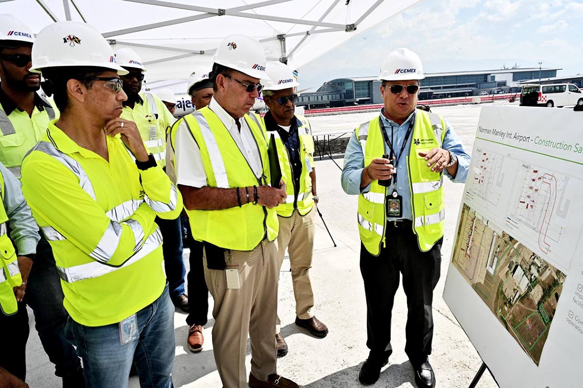 Caption: From left, Jorge Martinez, country manager of Cemex Jamaica and managing director of Carib Cement; Minister of Energy, Transport and Telecommunications Daryl Vaz; and Airports Authority of Jamaica Chairman Dr Douglas Lindo listen as PAC Kingston A
