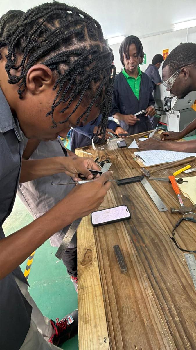 Students working on projects at the GENR8 3D laboratory in Montego Bay, St James.