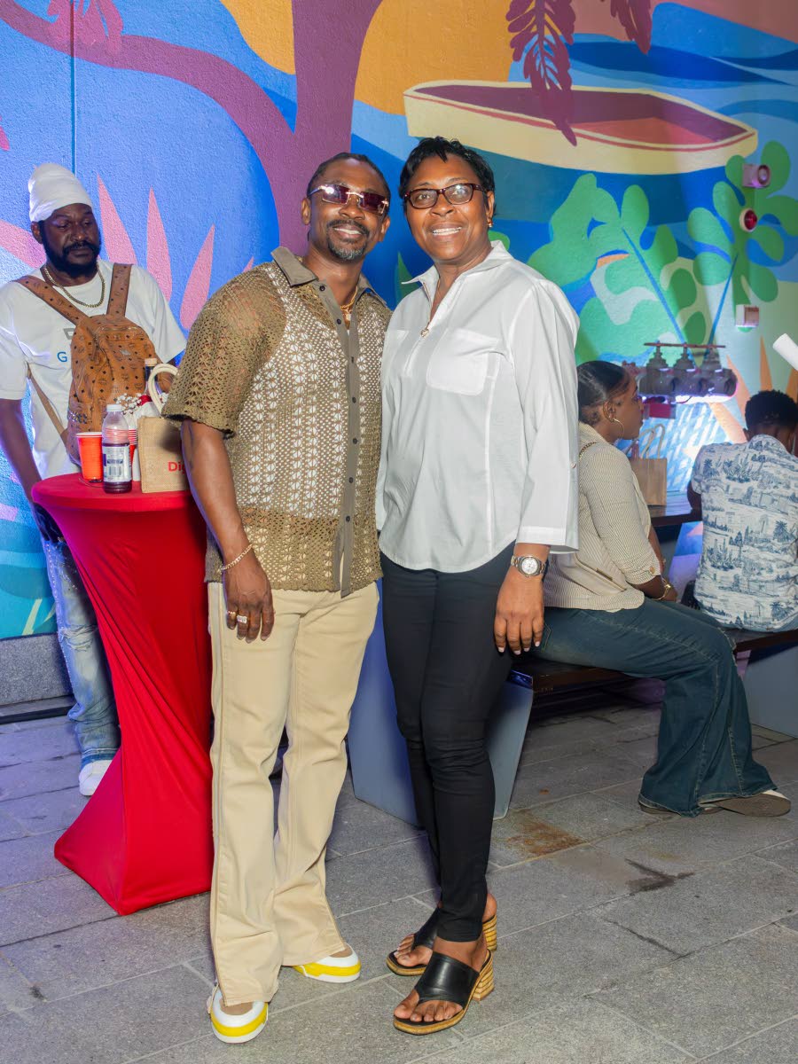 Reggae artiste Christopher Martin (left) and Senior Superintendent of Police Stephanie Lindsay pose for a photograph as they join in the celebrations.