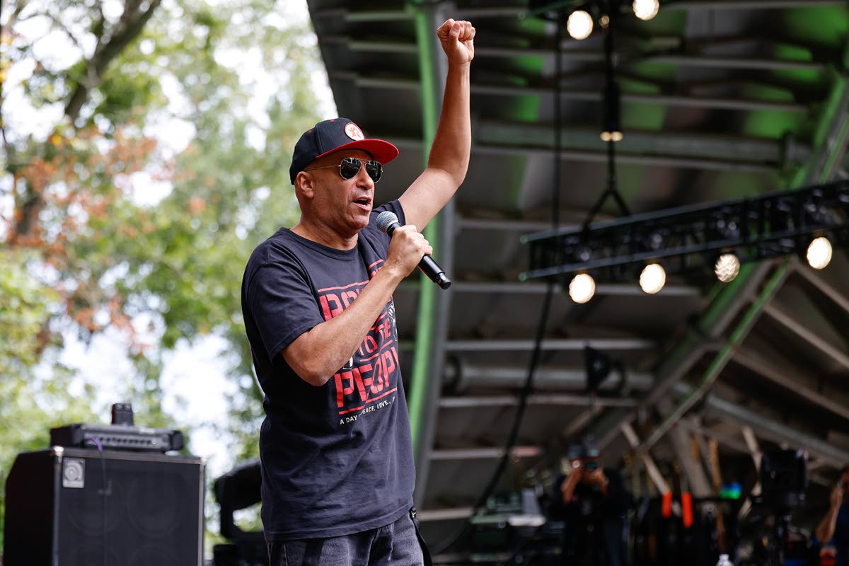 Tom Morello announces the first act of the day during the Power To The People Festival on Saturday, in Columbia, Md.