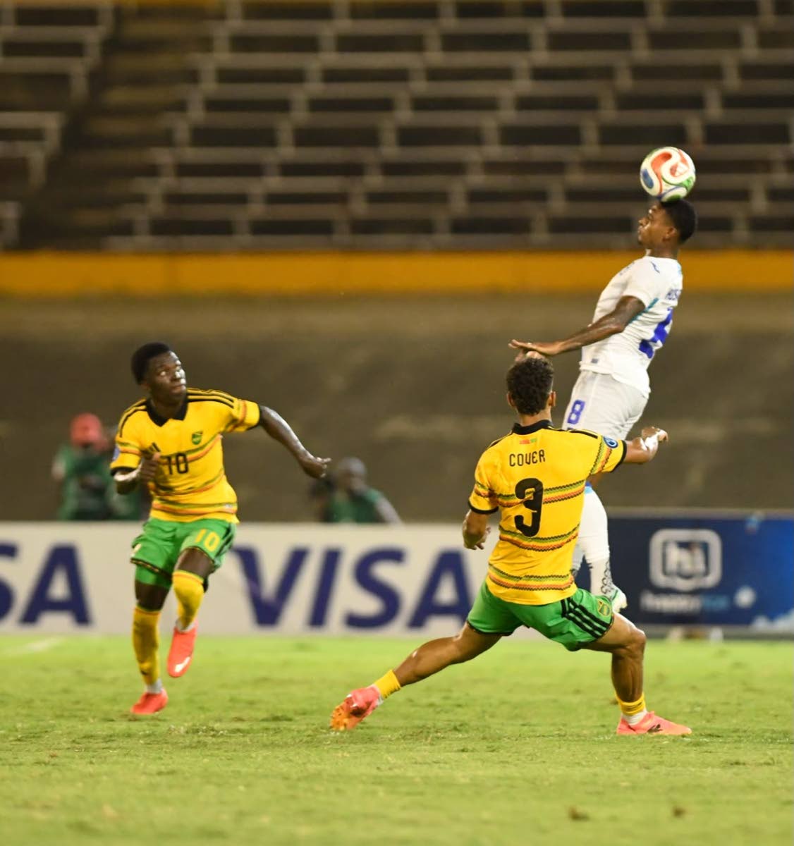  Honduras defender Joseph Rosales  (right) heads the ball while being closely watched by Jamaica's Kaheim Dixon (left) and Brandon Cover during last Monday's Concacaf Nations League match at the National Stadium. Honduras won 1-0. 