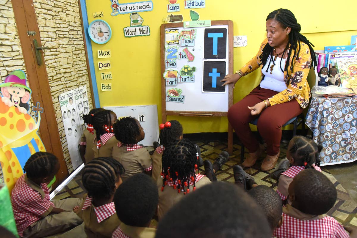 Master teacher Racheal Daley guiding her four-year-old students through a lesson on the letter ‘T’ at the Waterford Infant School in Portmore, St Catherine, on Wednesday.