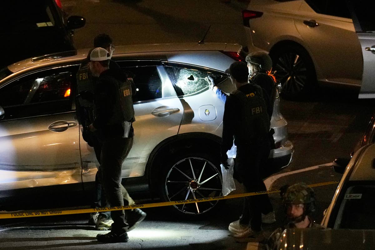 FBI agents perform an investigation at the scene of a shooting on Thursday, Oct. 8, 2026, in New York. (AP Photo/Seth Wenig)