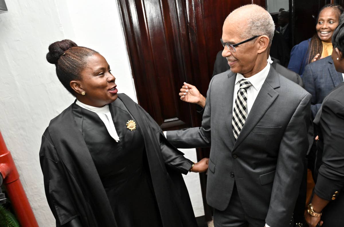 Former president of the Court of Appeal, Justice Patrick Brooks, congratulates Deputy Solicitor General Lisa White, KC, on her admission to the Inner Bar.