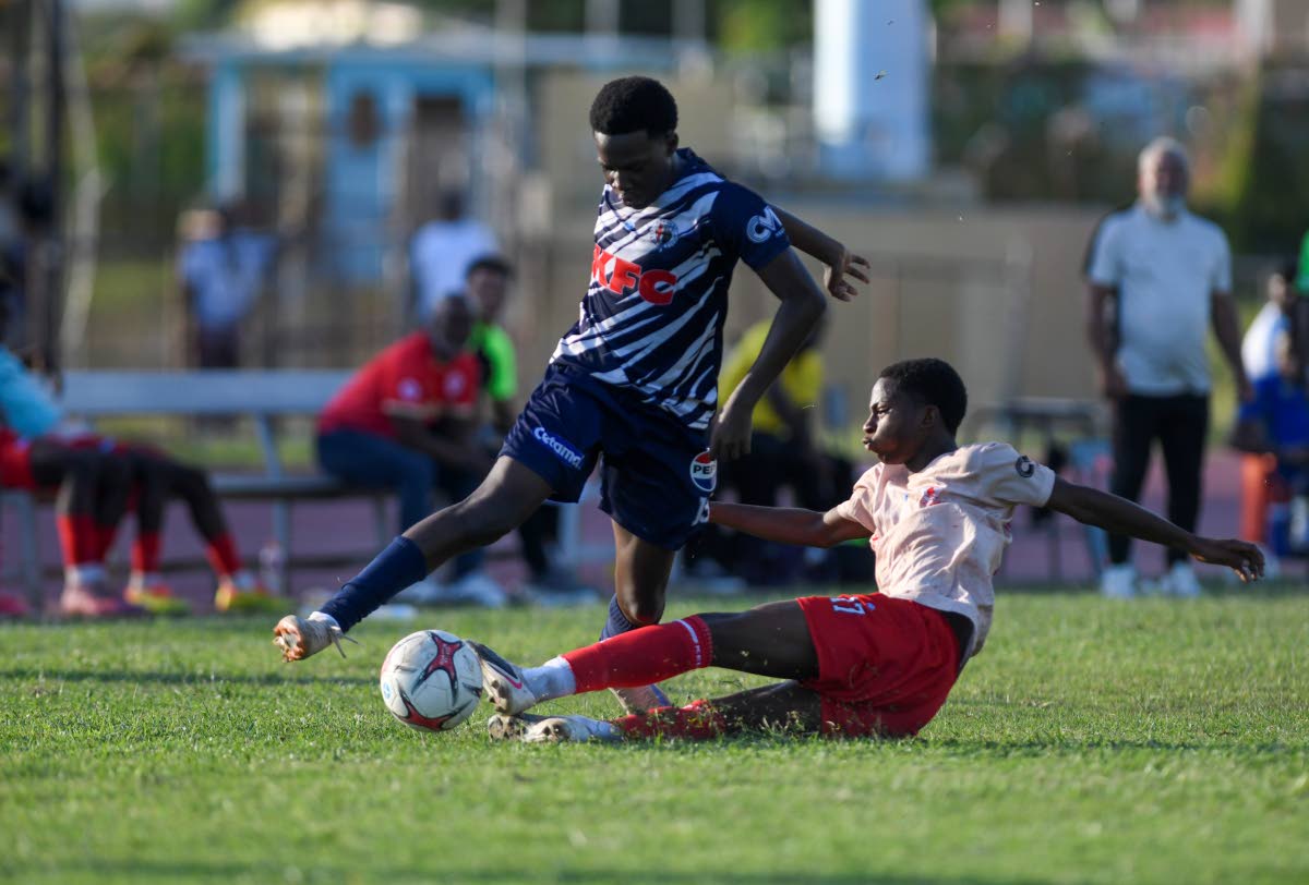 Shaquille Lindo (right) of Mona High School  puts in a firm tackle on Gerveir Grant of Jamaica College during the Walker Cup semi-final match between Jamaica College and Mona High School held on October 10, 2026 at the Stadium East field. 