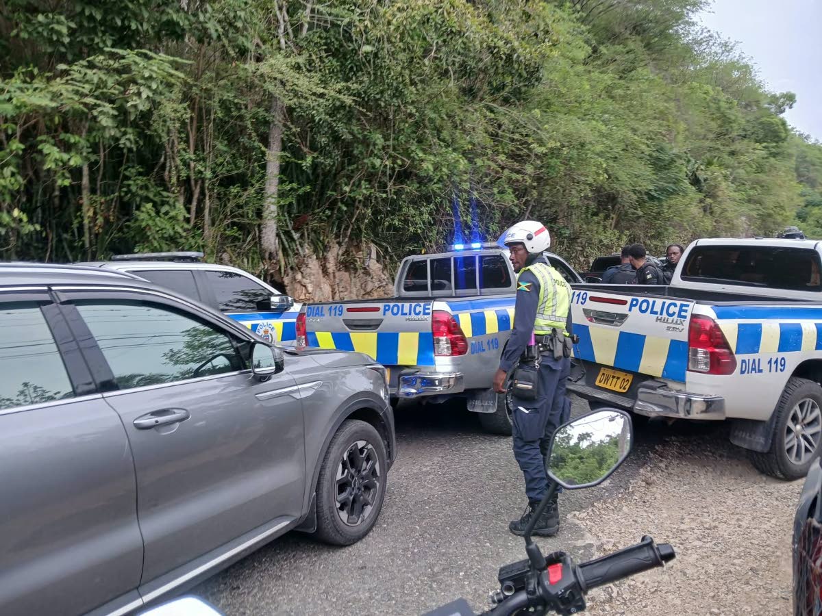 The police at the scene of gun battle between cops and gunmen in Sligoville, St Catherine on October 16. 